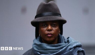 Diezani Alison-Madueke arrives at Southwark Crown Court on 26 January. She is looking at the camera, and wearing a blue scarf and brown hat