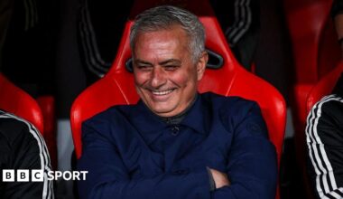 Jose Mourinho smiles and folds his arms