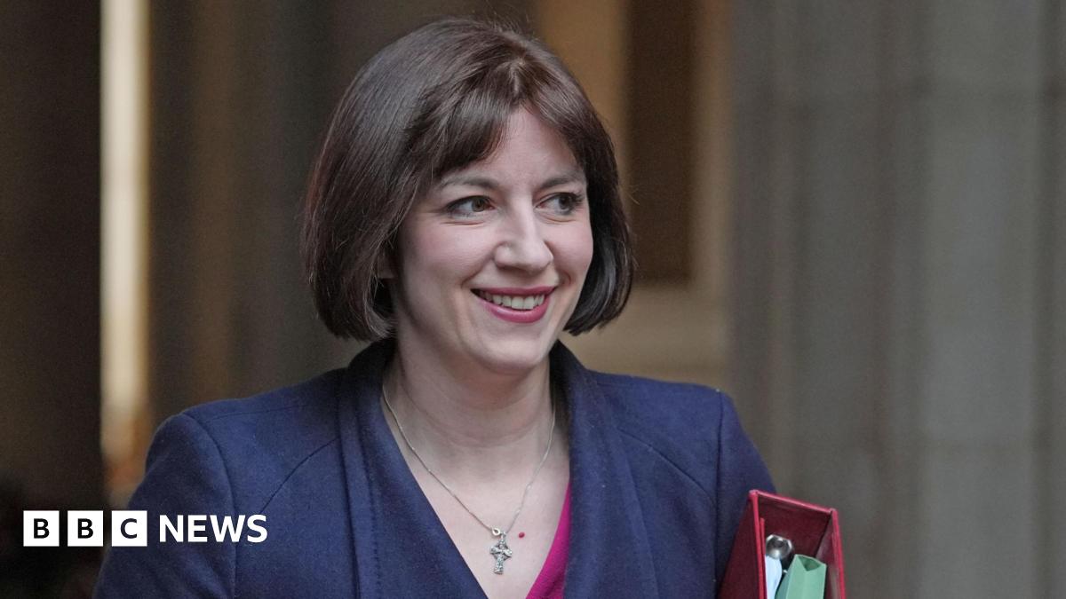 A head and shoulders shot shows Bridget Phillipson wearing a navy coat, carrying a red folder with documents inside, as she arrives for a recent Cabinet meeting in Downing Street.
