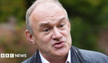 Liberal Democrats leader Sir Ed Davey, wearing a dark green jacket, is pictured speaking