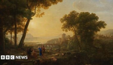 A painting shows Arcadian shepherds making music and tending their flocks in the foreground. Behind them are buildings and a castle with a bridge over a river and a bay beyond.