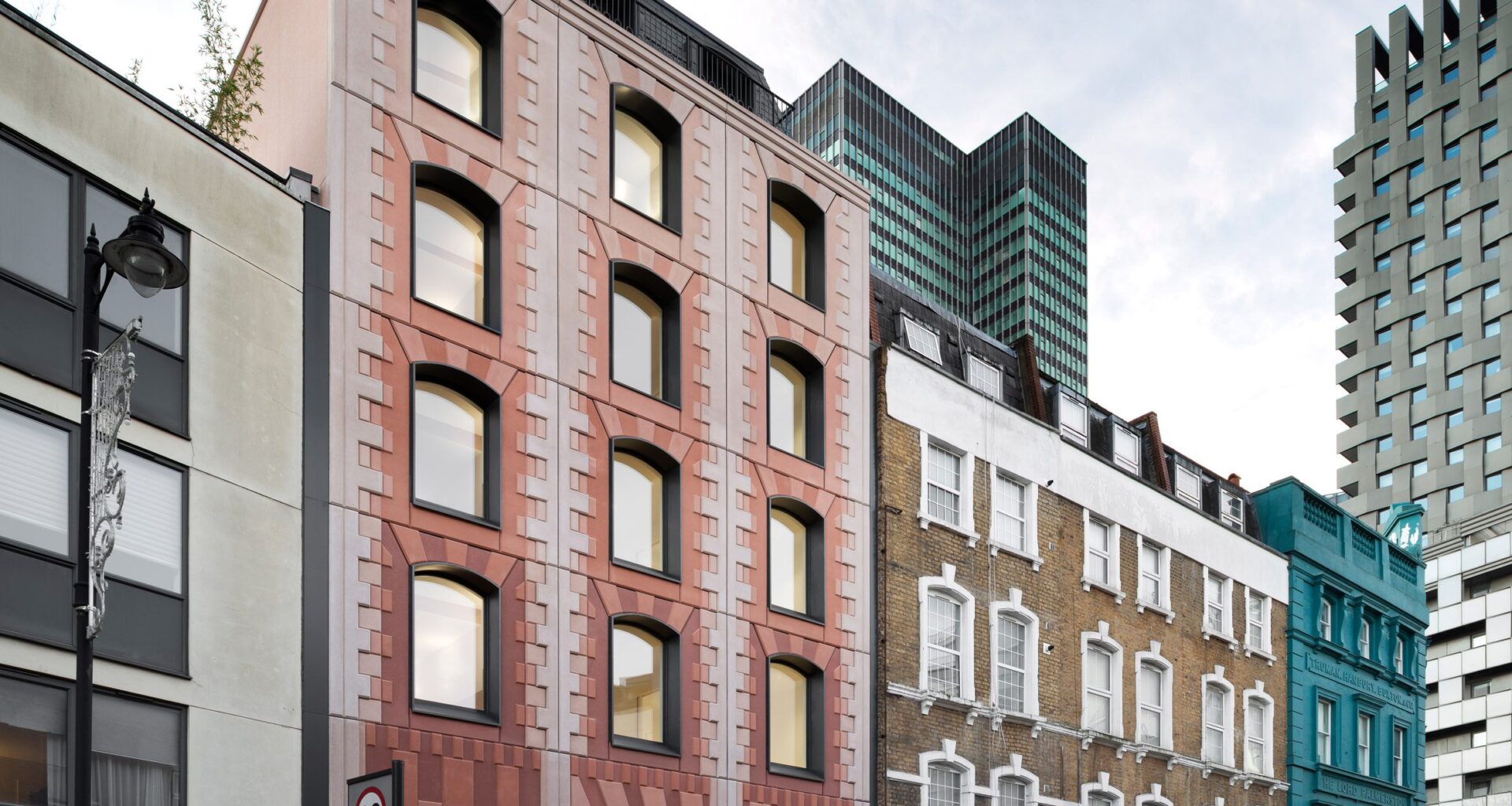 Bureau de Change enlivens apartment block with pink panels