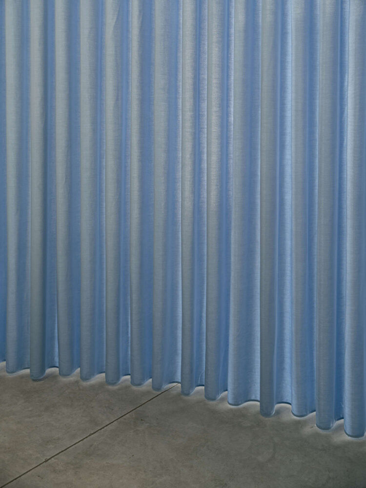 the textile curtain introduces softness and permeability