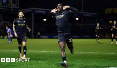 Plymouth Argyle's Aribim Pepple cups his hands to his ears as he runs to the fans to celebrate his match-winning goal.
