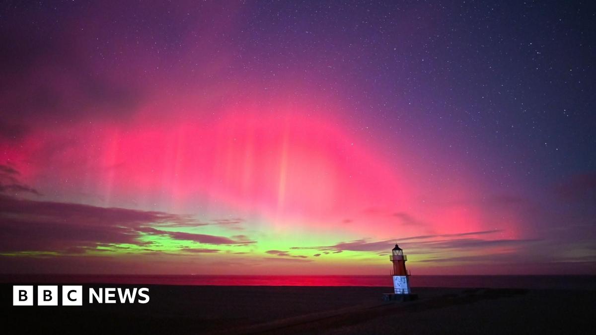 Donald Trump and Keir Starmer sit in a formal drawing room setting  on arm chairs with US and UK  flags behind them. Both have serious expressions and are looking out and not at each other.