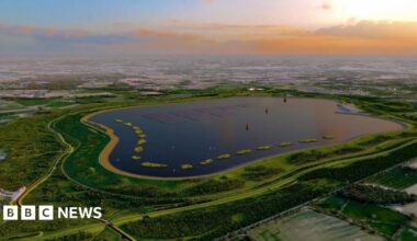 An artist's aerial view of how the new reservoir would look as the sun sets on the horizon.