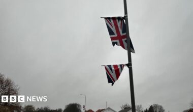 A union flag cut in half on a flag pole