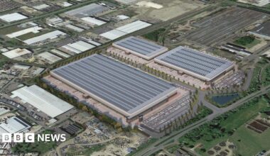 Aerial shot showing three new large buildings surrounded by roads and car parks.