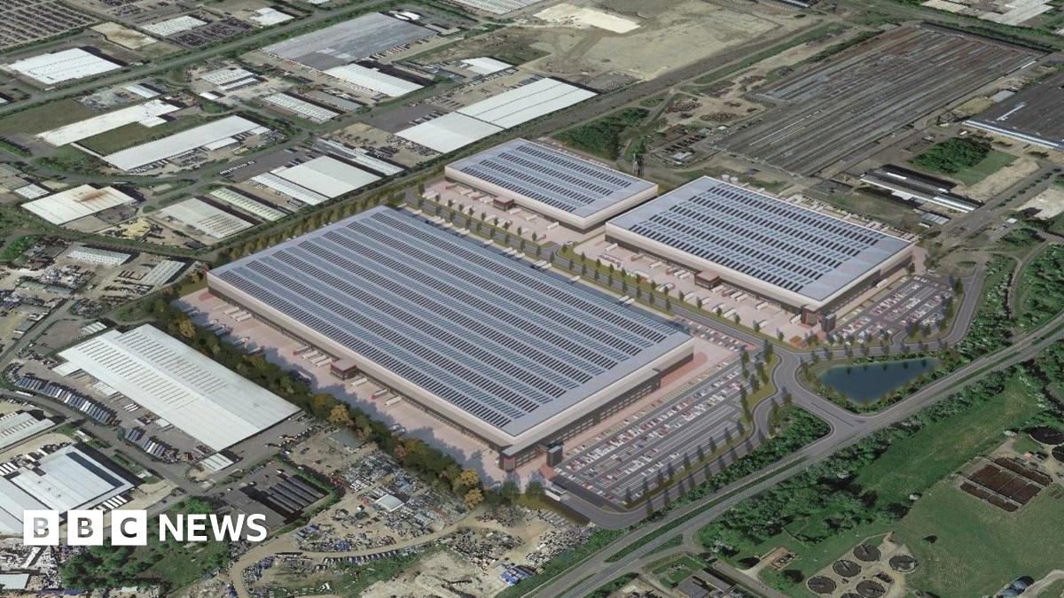 Aerial shot showing three new large buildings surrounded by roads and car parks.