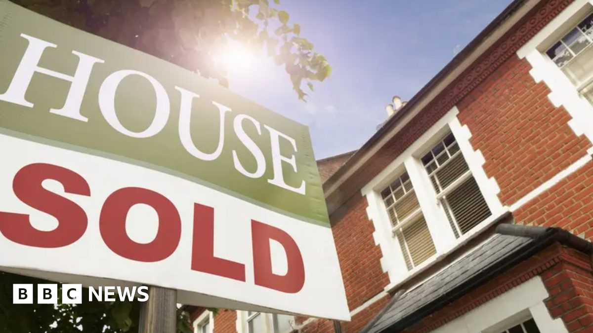Stock image of a 'house sold' sign in front of a property.