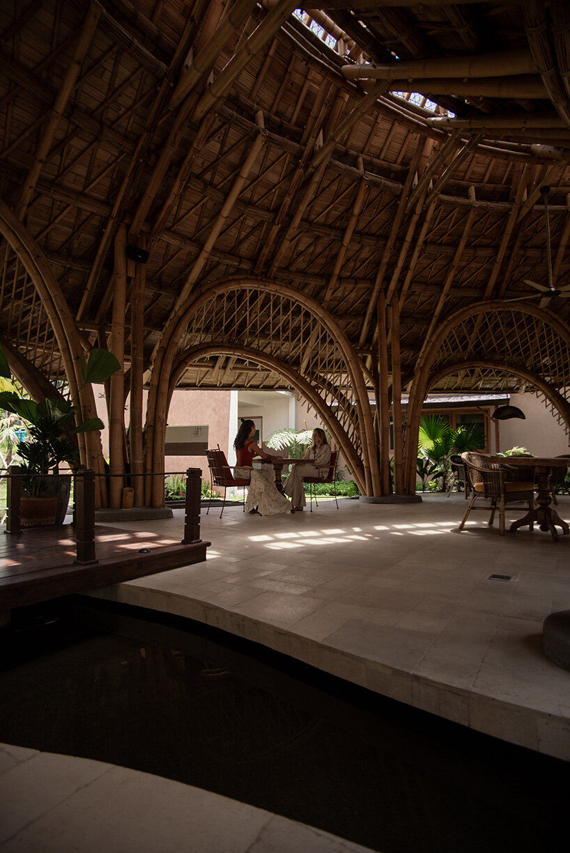 circular bamboo roof collects rainwater at balinese restaurant by pablo luna studio