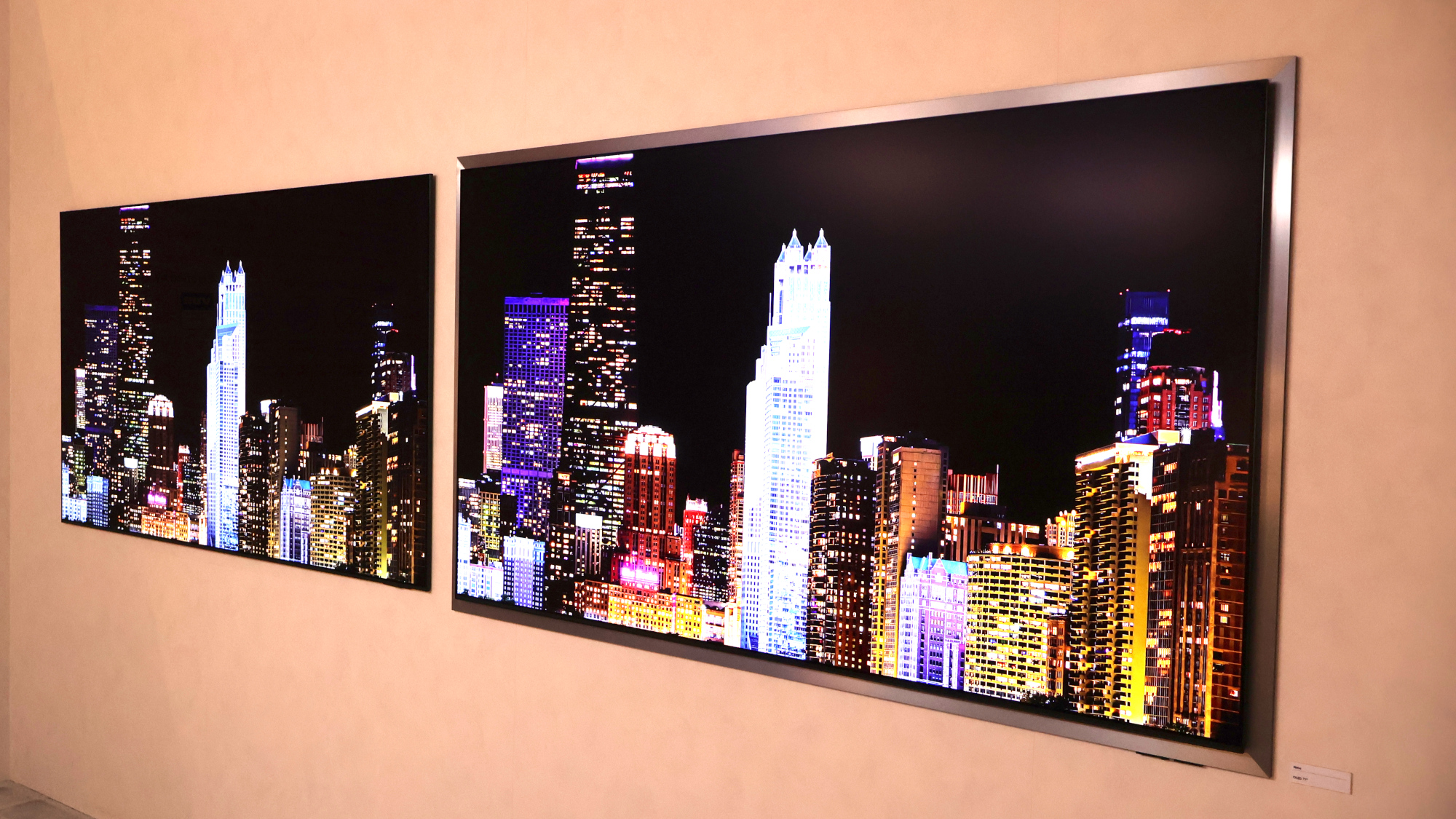 The Samsung S95H OLED on right with its new metal bezel.