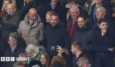 Nicky Butt (grey coat) and Paul Scholes to his left sat with former manager Sir Alex Ferguson (red scarf) at Manchester United's FA Cup defeat by Brighton