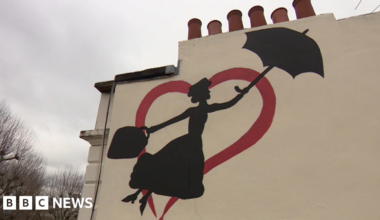 The mural shows Mary Poppins holding an umbrella in her left hand and a carpet bag in her right, flying towards a real-life chimney in the outline of a red heart.