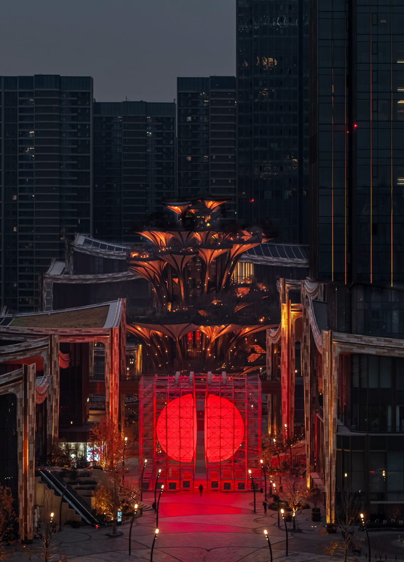 SpY's monumental divided sphere installation illuminates xi’an in bright red light