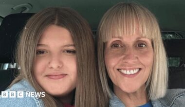 A mother and daughter pose for a selfie inside a car