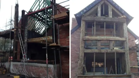 Celia Wilson Two side‑by‑side photos showing a brick building under major construction.

Left photo: A partially built structure stands surrounded by scaffolding. The walls are made of red brick, and the wooden roof frame is exposed, with green timbers forming the skeleton of a pitched roof. Several beams and planks are supported by metal poles, and ladders lean against the structure. The lower part of the building is open, with no windows or doors installed yet. Building materials and tools are scattered around the site.

Right photo: This image shows the front of the same building from a straight‑on view. The full height of the structure is visible—three storeys tall—with a steep, triangular roof. The façade features large, thick, weathered wooden beams forming the framework for what will likely be large windows. The interior is still empty and unfinished, with floors and ceilings visible through the open spaces. A ladder stands inside the ground floor, and more scaffolding is set up around the sides.
