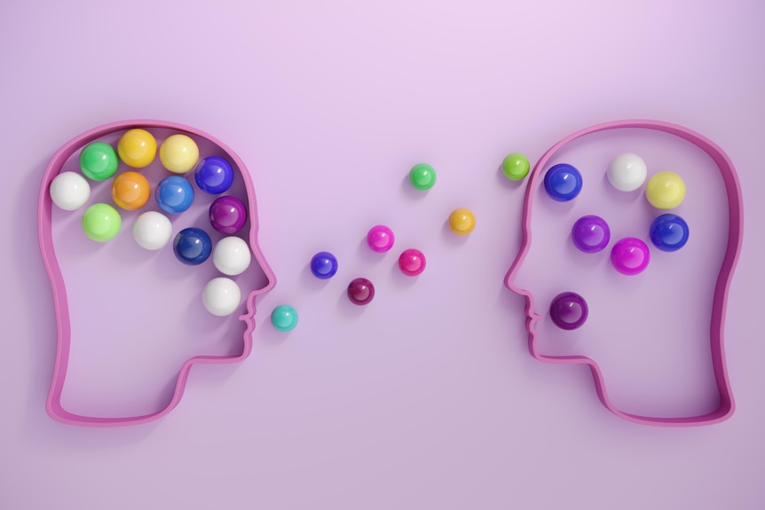 Plastic rainbow balls inside a silhouette of someone's head.