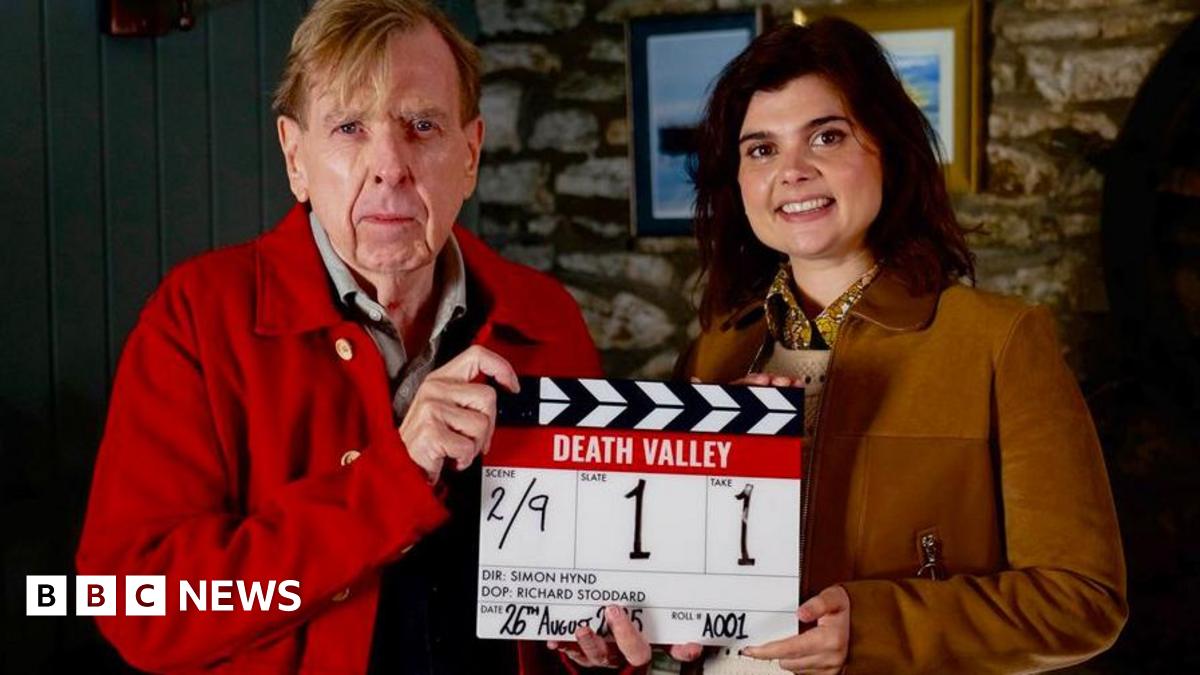 Timothy Spall, who plays John Chapel and Gwyneth Keyworth, who plays, Janie Mallowan holding a production slate for Death Valley
