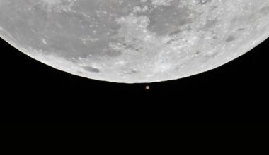 The first full moon of the 2025 called 'Wolf Moon' that seen next to Mars rises over the sky during a lunar occultation of Mars in Charlotte, United States on January 13, 2025.