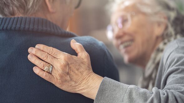 Elderly couple supporting each other