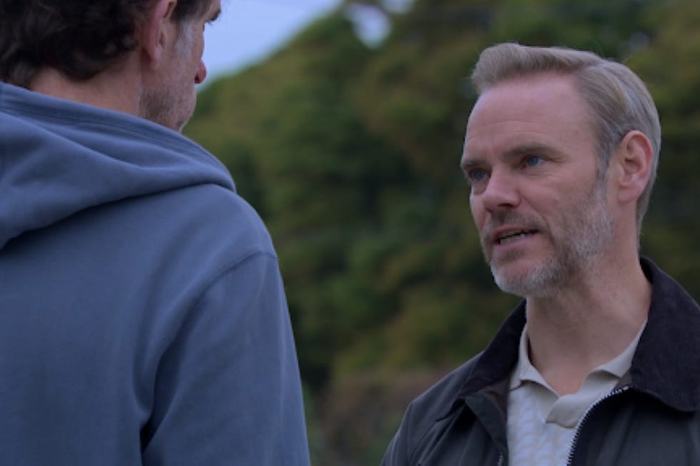 two individuals engaged in conversation outdoors