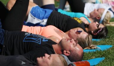 Participants sweat while taking part in the yoga workout. (Photo: Jason Bahr/Getty Images)