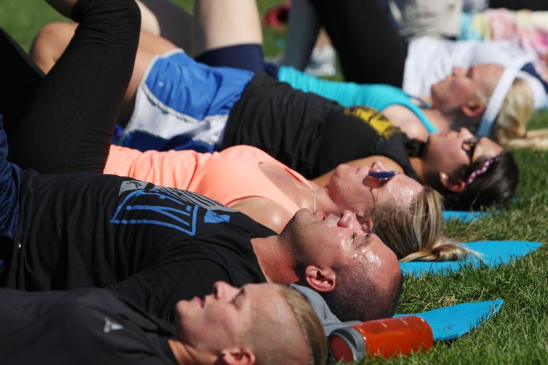 Participants sweat while taking part in the yoga workout. (Photo: Jason Bahr/Getty Images)