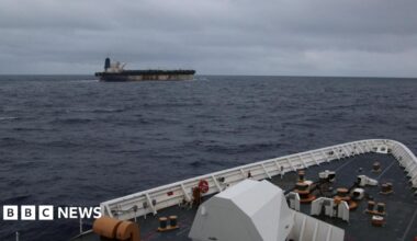 The shadow fleet ship Marinera seen in the distance from the upper decks of a US coastguard cutter following her.