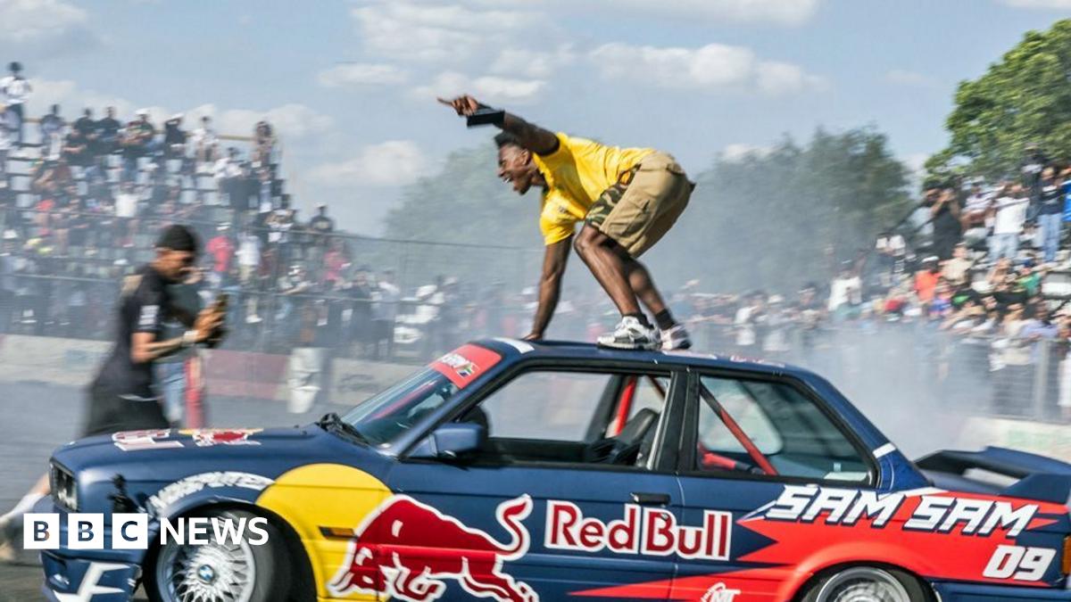 A woman looking at her mobile phone and the graphic BBC News Africa