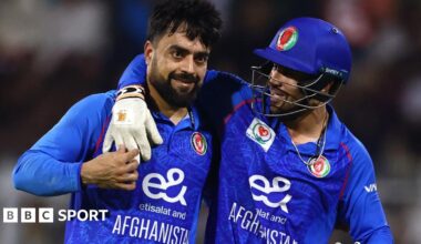 Rashid Khan is embraced by a team-mate while playing for Afghanistan