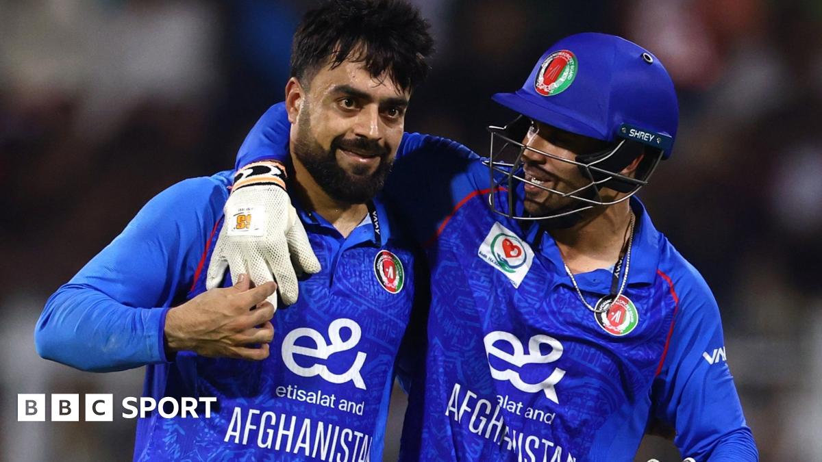 Rashid Khan is embraced by a team-mate while playing for Afghanistan
