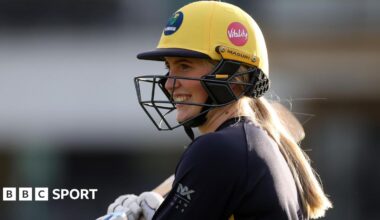 Charlotte Scarborough smiling through her batting helmet