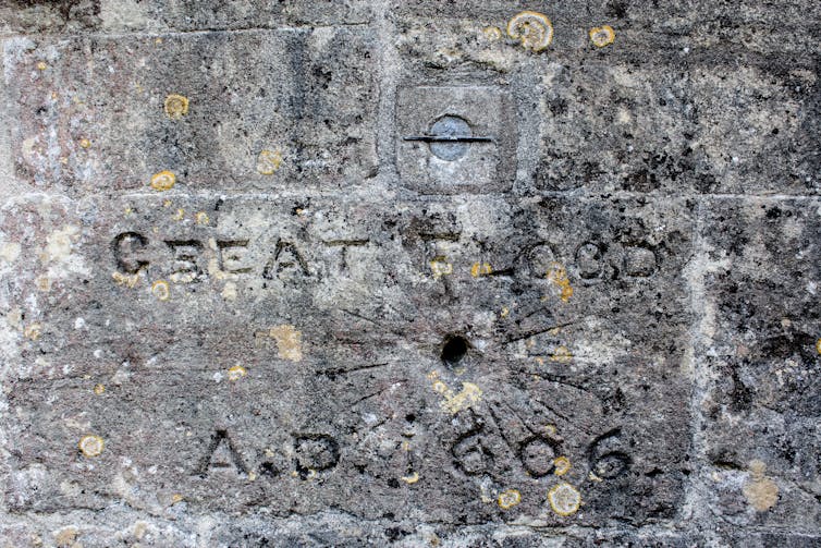 A stone marker with carvings depicting the height of the great flood.