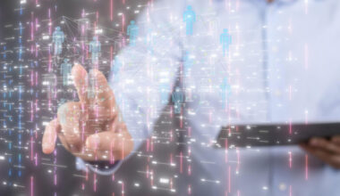 A person interacts with a virtual projection displaying digital human icons and data visualizations, representing artificial intelligence.