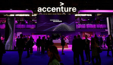 The Accenture logo is displayed above a busy pavilion with people networking and talking.