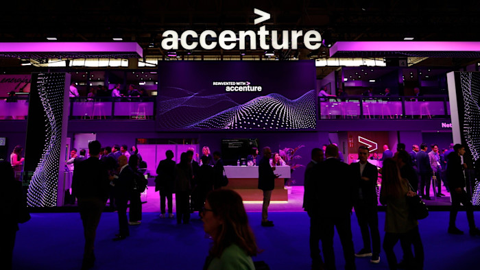 The Accenture logo is displayed above a busy pavilion with people networking and talking.