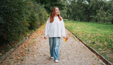 woman walks mindfully in a park in the autumn