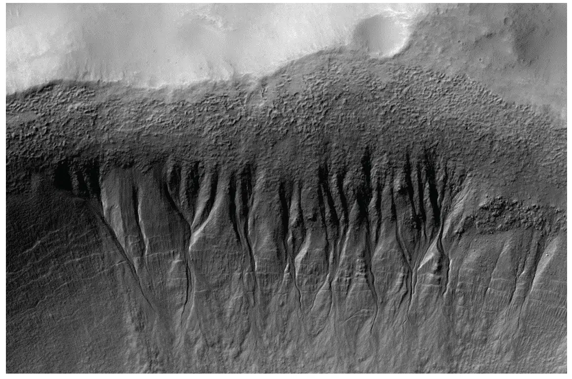 Mid-latitude martian gullies at 37.46°S, 222.95°E, exhibiting erosional alcoves, channels, and depositional aprons; all geological features that appear to be actively evolving and resemble landforms that on Earth are formed by water. Credit: National Academy of Sciences
