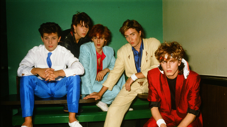 Members of Duran Duran posing in blazers