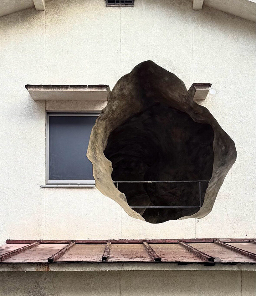 irregular voids carve cave-like, geological interior inside japanese residence