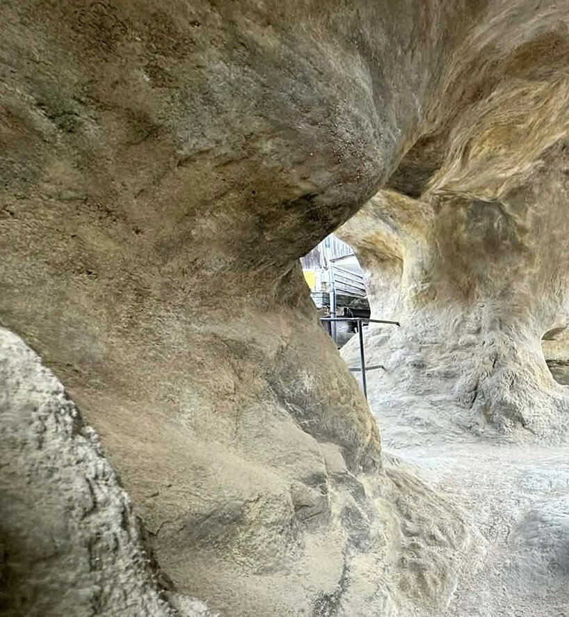 irregular voids reveal cave-like, geological interior inside japanese residence