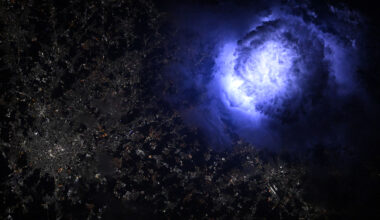 Lightning turns a cloud formation an eerie blue above Milan, Italy. The view is from the International Space Station.