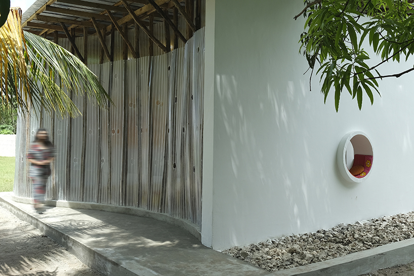 perforated corrugated panels regulate light and ventilation at library in tanzania