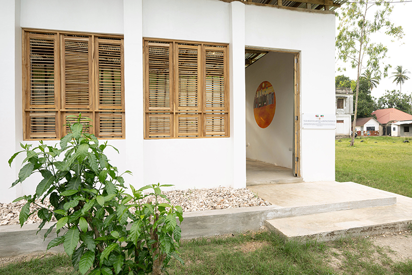 perforated corrugated panels regulate light and ventilation at library in tanzania