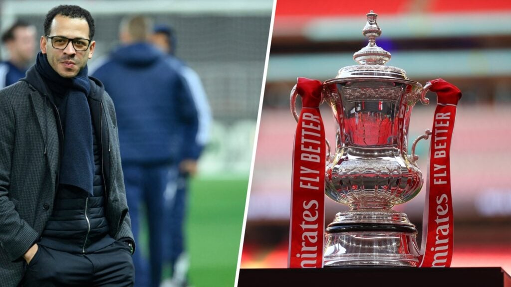 Strasbourg manager Liam Rosenior with hands in pocket and FA Cup trophy on display