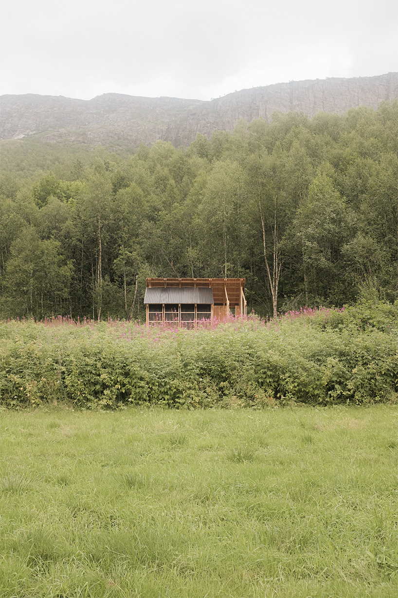 student collective builds fireplace shelter from reclaimed materials in northern norway