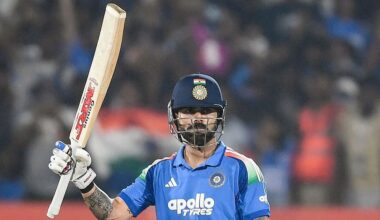 India batter Virat Kohli raises his bat to celebrate a century for his team.