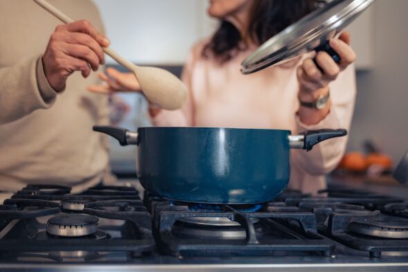 Middle aged couple cooking healthy soup Middle aged couple cooking healthy soup