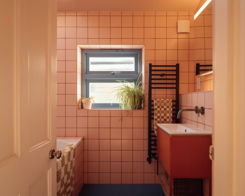 Pink bathroom at dwelling by Nimtim Architects